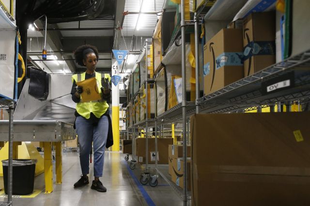 Amazon temporarily raises overtime pay for warehouse workers